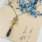 Flower and Onyx Drop Pendant Necklace by Eric et Lydie